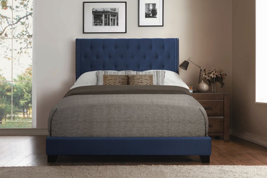 Blue upholstered bed with a tufted headboard.
