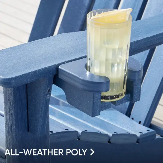 ALL-WEATHER POLY. A blue Adirondack chair armrest with a built-in cup holder containing a glass of lemonade.