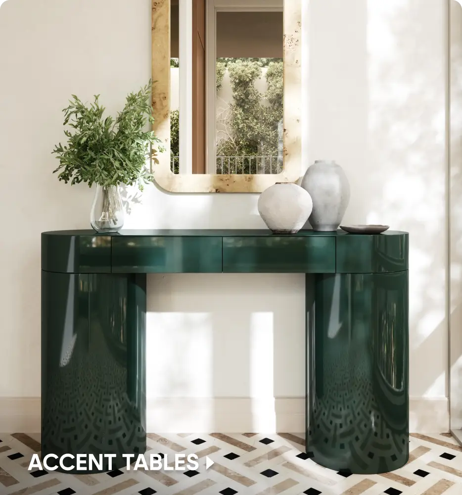 ACCENT TABLES. A glossy dark green console table with rounded legs sits beneath a burl wood mirror.
