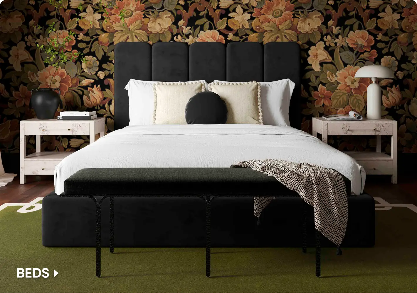 BEDS. A modern black upholstered bed with a floral wallpaper background, flanked by two light-colored nightstands.