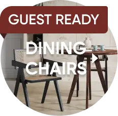 GUEST READY DINING CHAIRS. A modern black dining chair with a cane back and seat next to a wooden table.