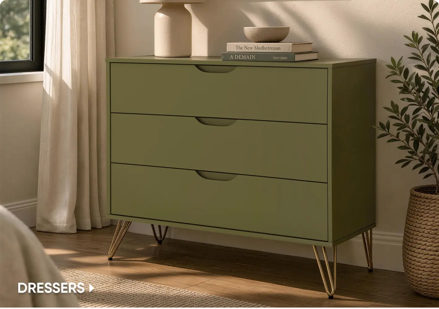 DRESSERS: A modern olive green three-drawer dresser with gold hairpin legs, styled with books and a lamp.