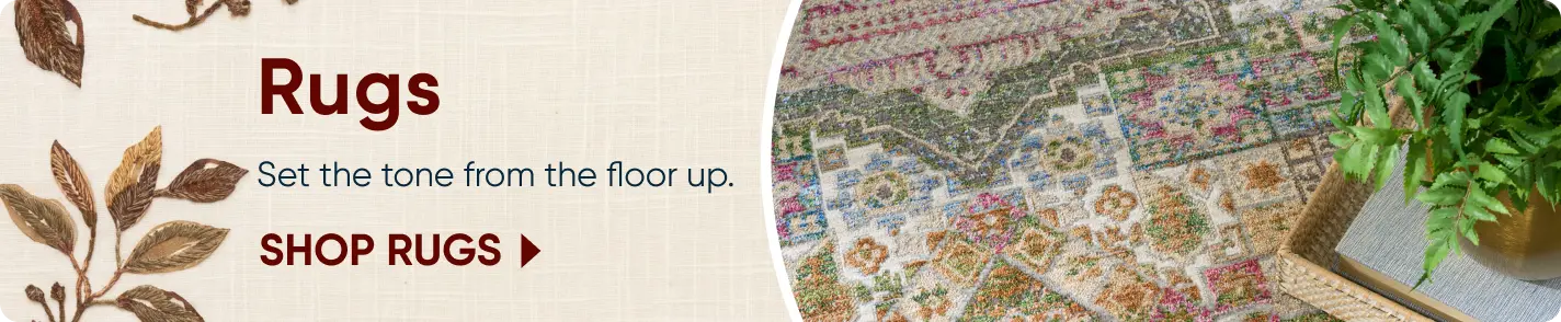 Rugs: Set the tone from the floor up. SHOP RUGS. A colorful, patterned area rug with a green plant in the corner.