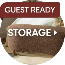 GUEST READY STORAGE. A brown, textured, curved storage bench sits at the foot of a bed.