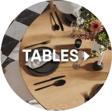 TABLES. A top-down view of a round wooden dining table set with black plates, cutlery, and a floral centerpiece.