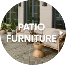 PATIO FURNITURE: A modern outdoor sofa with beige cushions and a wooden side table on a patterned rug.