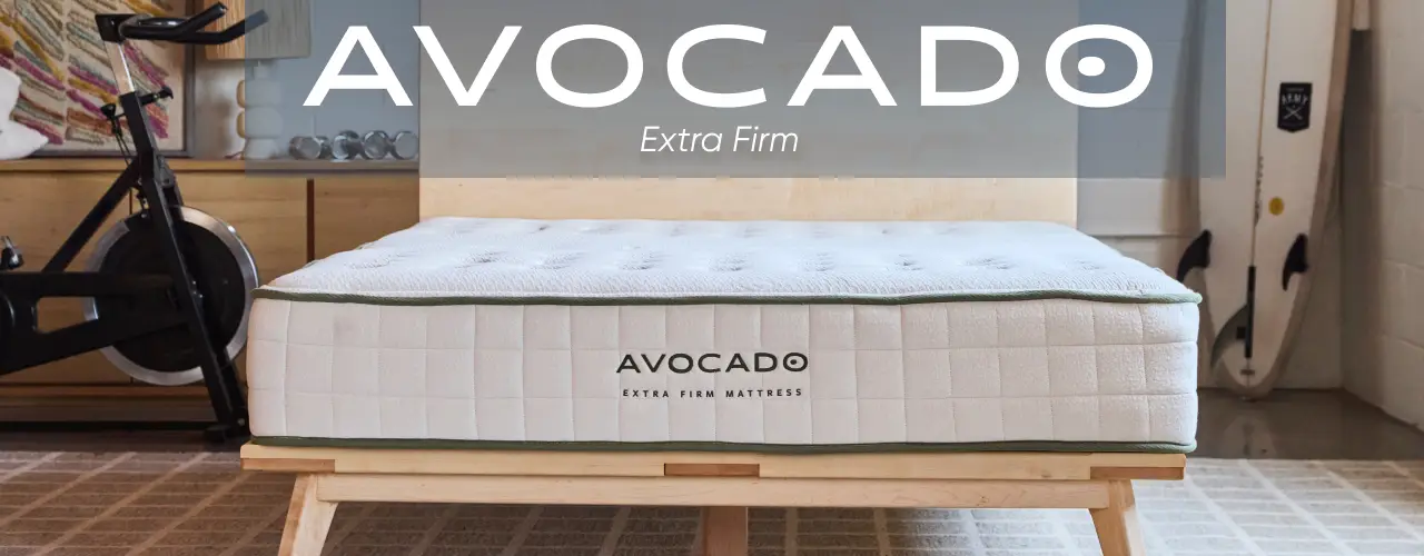 AVOCADO EXTRA FIRM mattress on a wooden bed frame.