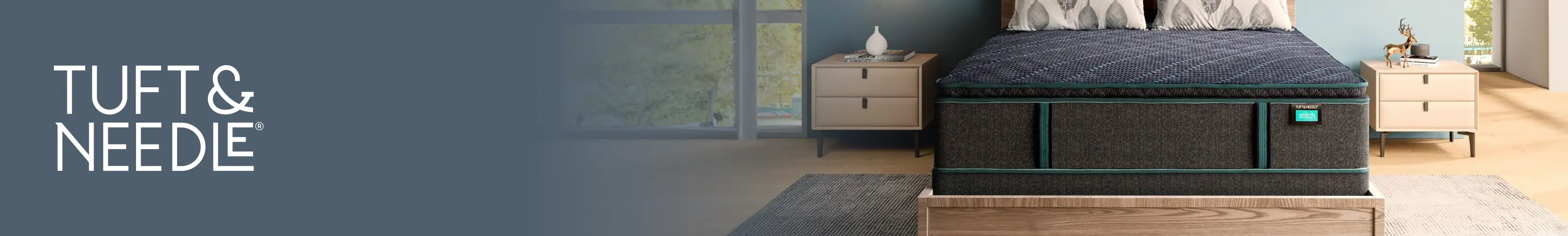 Tuft & Needle: A modern bedroom featuring a dark gray mattress with teal accents on a wooden bed frame.