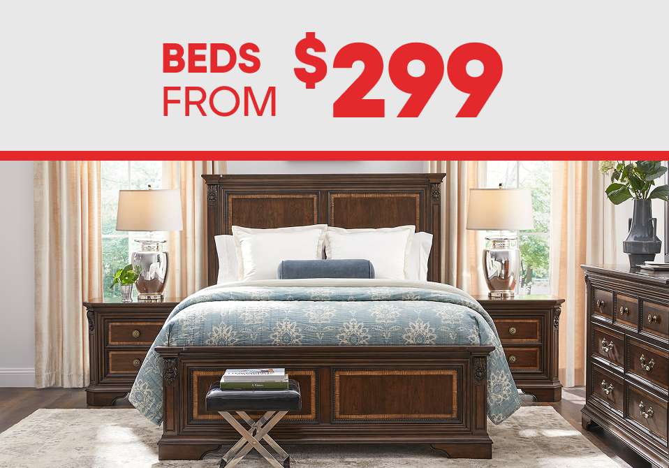 BEDS FROM $299. A bedroom set with a bed, nightstands, and a dresser.
