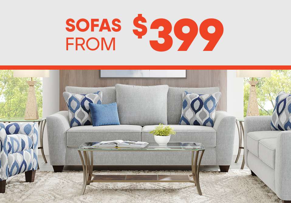 SOFAS FROM $399. A gray sofa with blue and gray patterned pillows.
