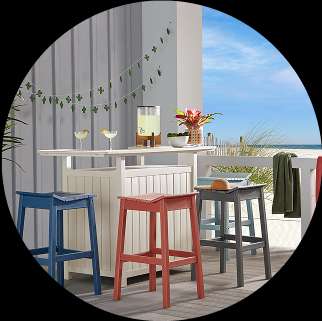 Outdoor bar with colorful stools and beach view.
