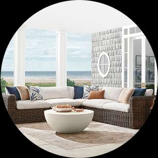 Outdoor sectional sofa with a coffee table on a rug.
