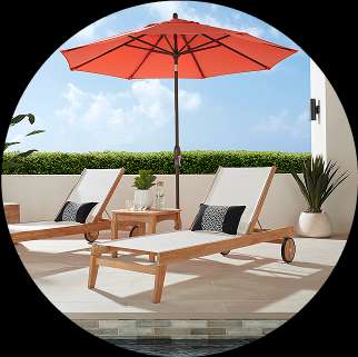Two white chaise lounges with black pillows under an orange umbrella.

