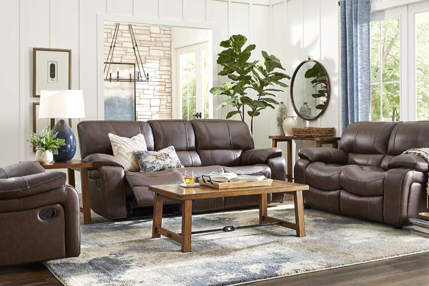 Brown leather reclining sofa set in a living room.
