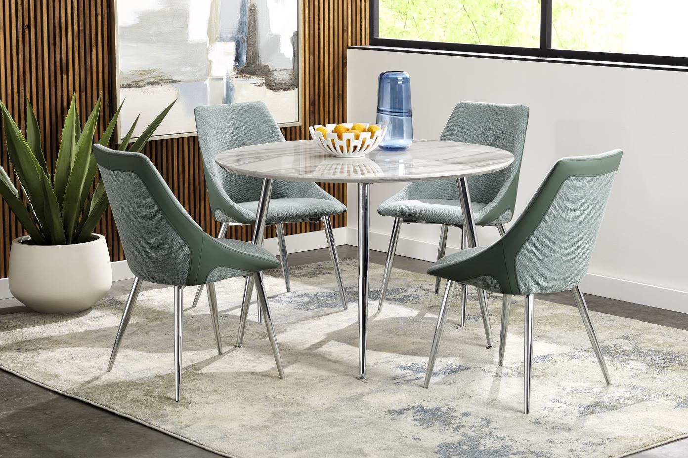 Dining table set with a round marble-look table and four chairs.

