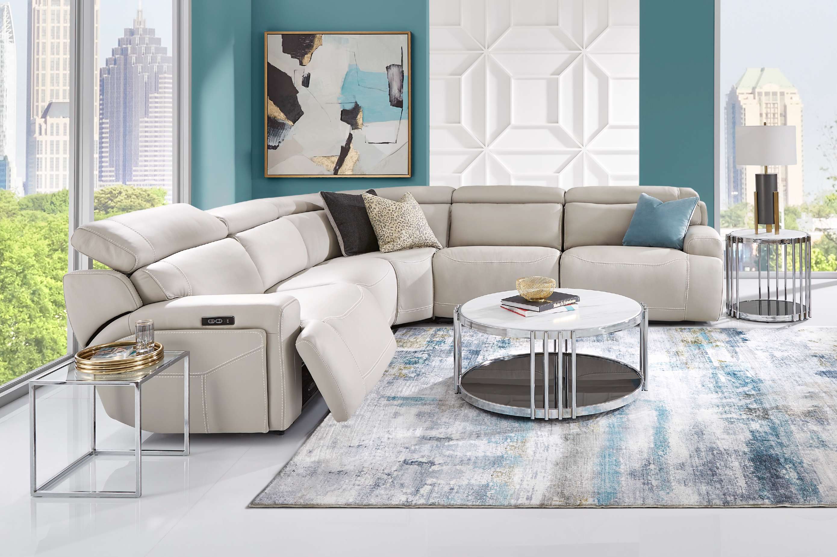 Cream-colored sectional sofa in a modern living room with a city view.
