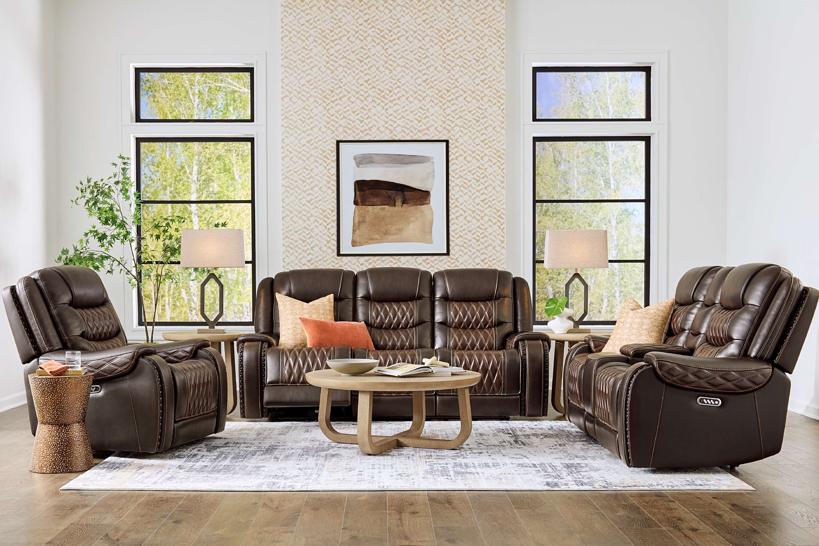 Brown leather reclining sofa and chairs in a living room setting.
