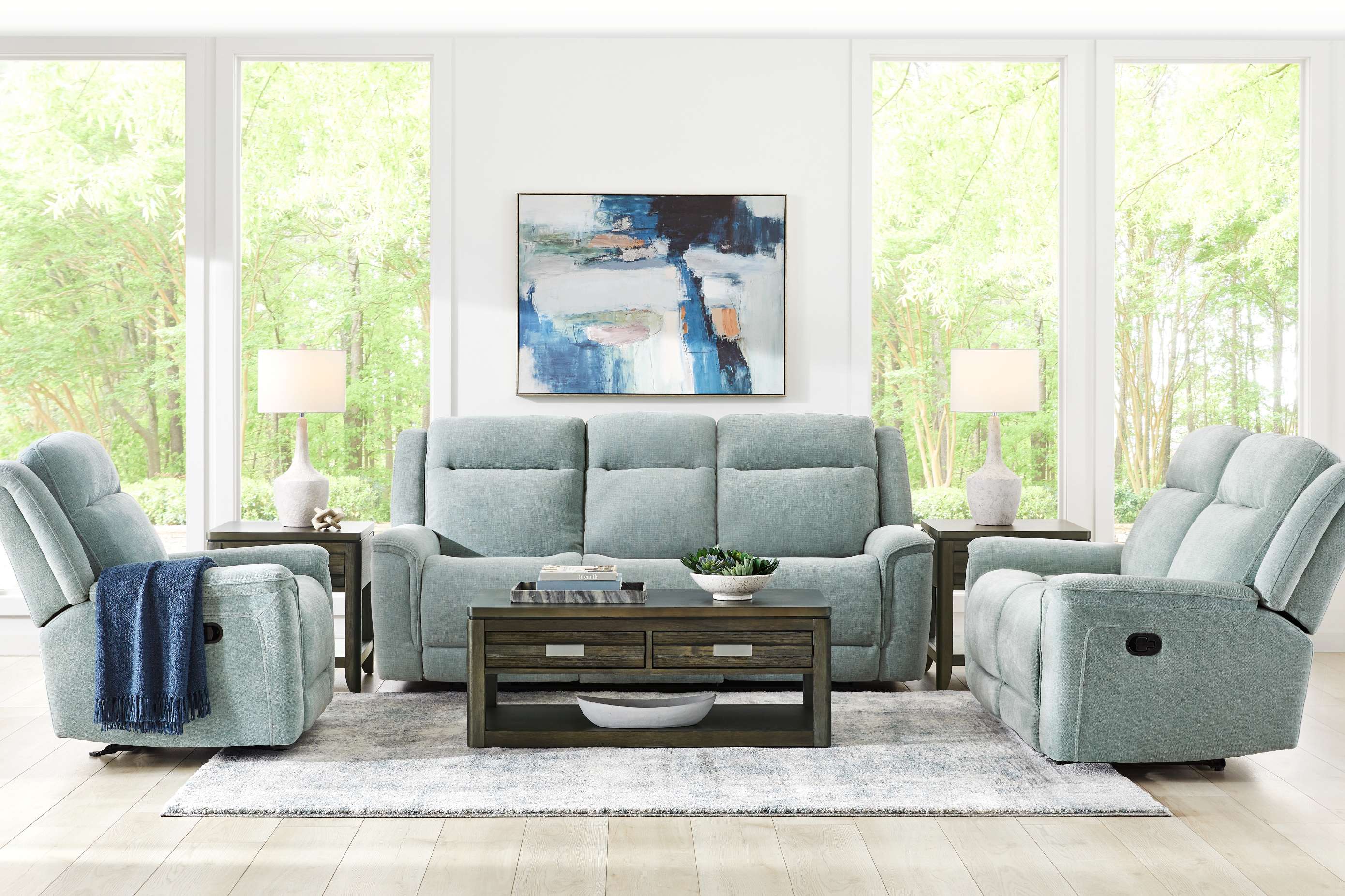 Living room furniture set with a sofa, two recliners, and a coffee table.
