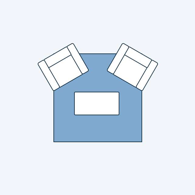 Top-down view of a living room layout with two armchairs and a coffee table on a blue rug.
