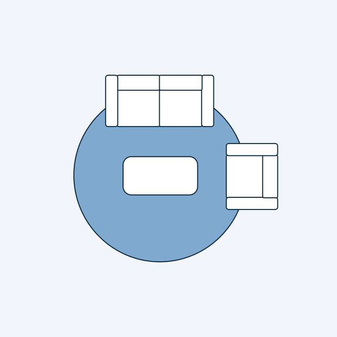 Top-down view of a living room layout with a sofa, coffee table, and side table on a blue circular rug.
