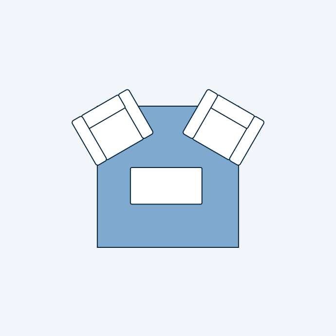 Top-down view of a living room layout with two armchairs and a rectangular coffee table.
