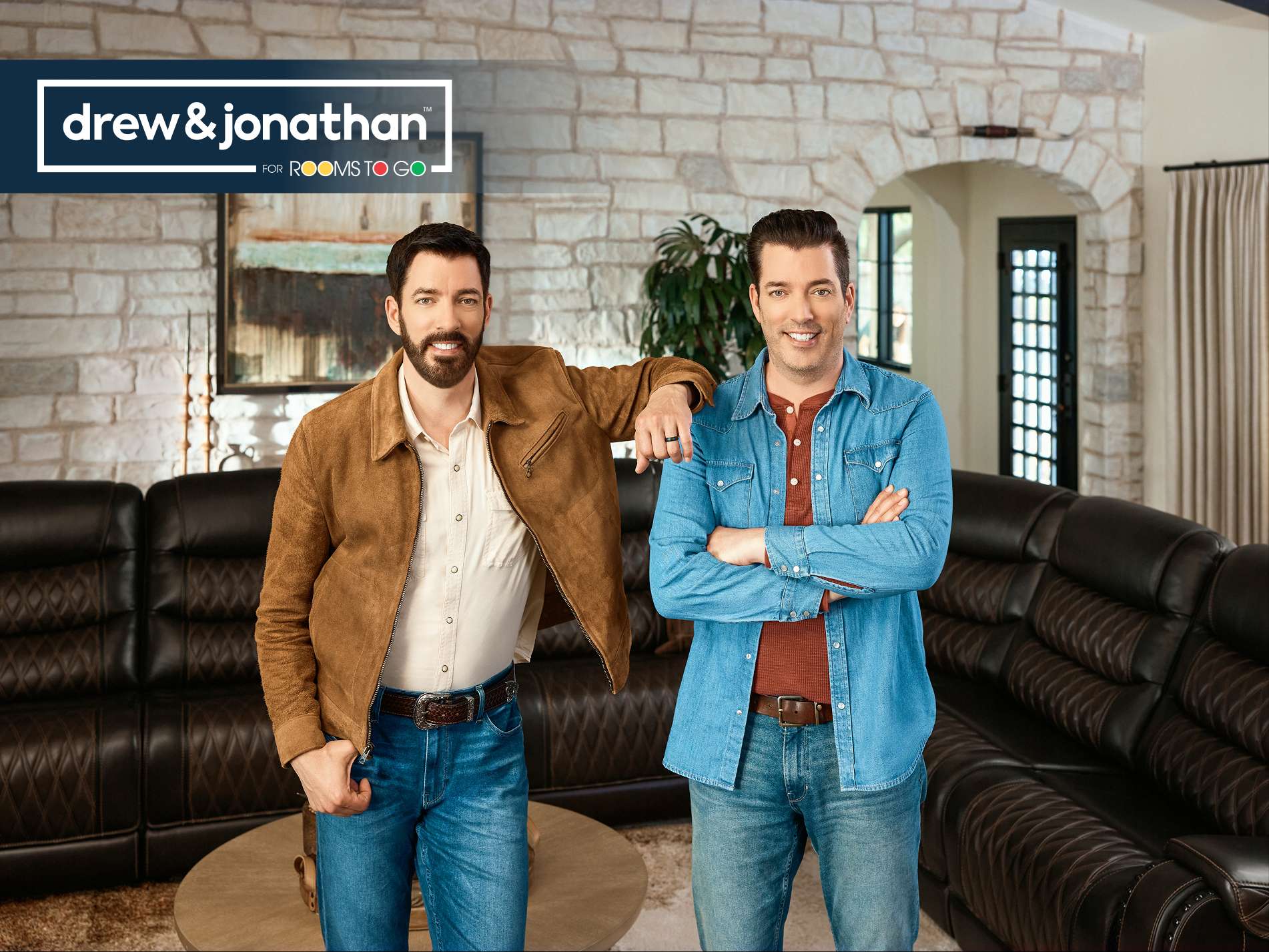 drew & jonathan for rooms to go. Two men standing in a living room.
