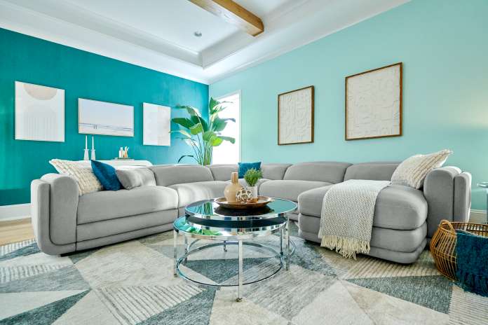gray couch with pillows and blanket on it 