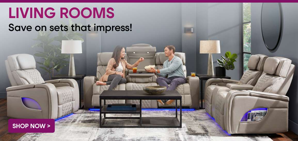 LIVING ROOMS. Save on sets that impress! A couple sitting on a gray reclining sofa with popcorn.
