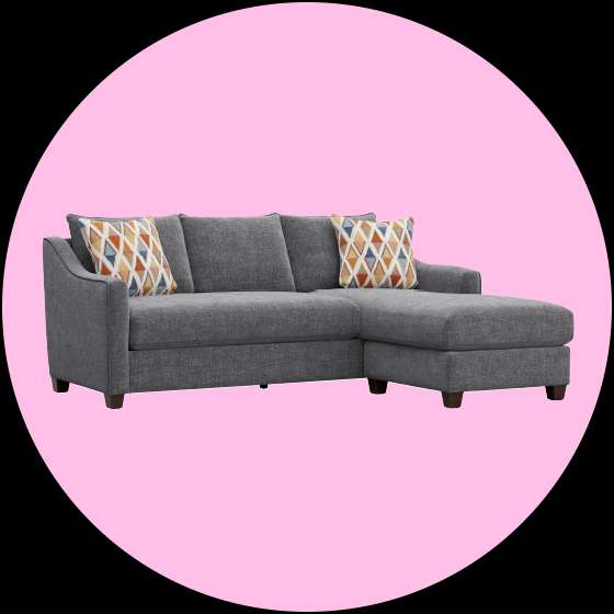 Gray sectional sofa with two patterned throw pillows.

