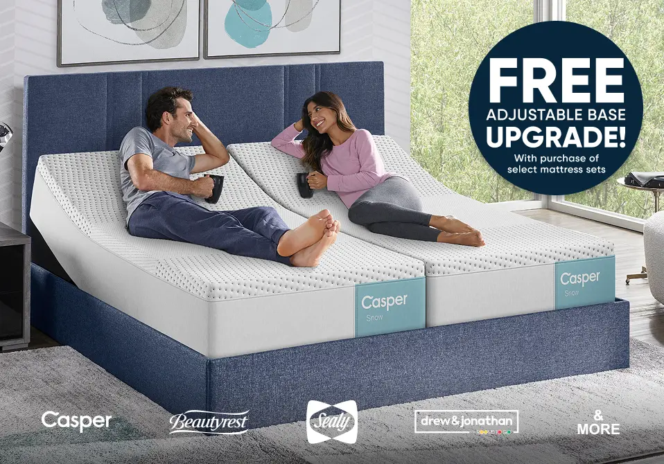 FREE ADJUSTABLE BASE UPGRADE! With purchase of select mattress sets. A couple relaxing on a split adjustable bed.