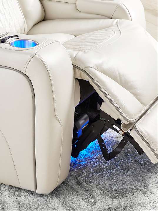 Cream-colored leather recliner with blue LED lighting and a cup holder.
