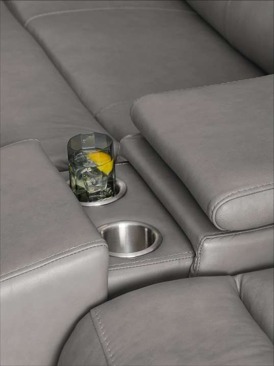 Gray leather sofa with a drink in a cup holder.
