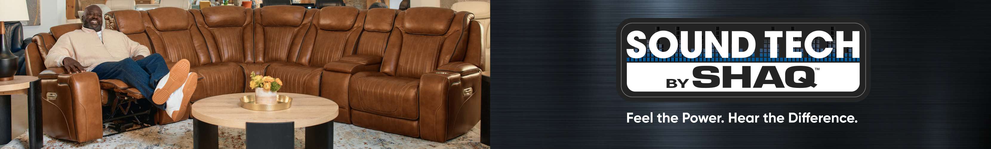 SOUND TECH by SHAQ. Feel the Power. Hear the Difference. A brown leather sectional sofa with Shaq sitting on it.
