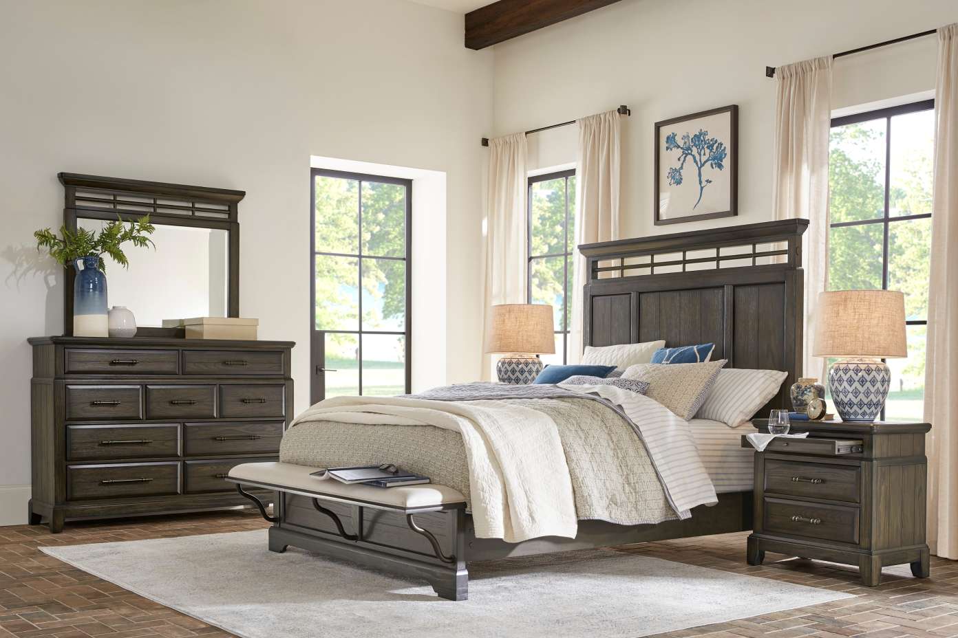 Bedroom furniture set with a bed, dresser, nightstand, and bench.
