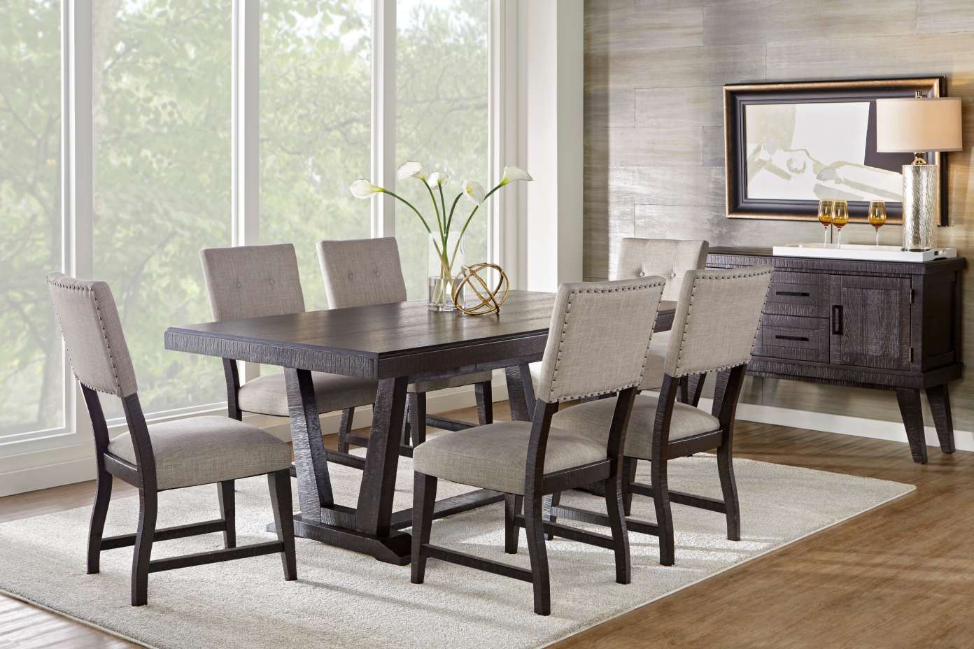 Dining room set with a dark wood table, six upholstered chairs, and a sideboard.
