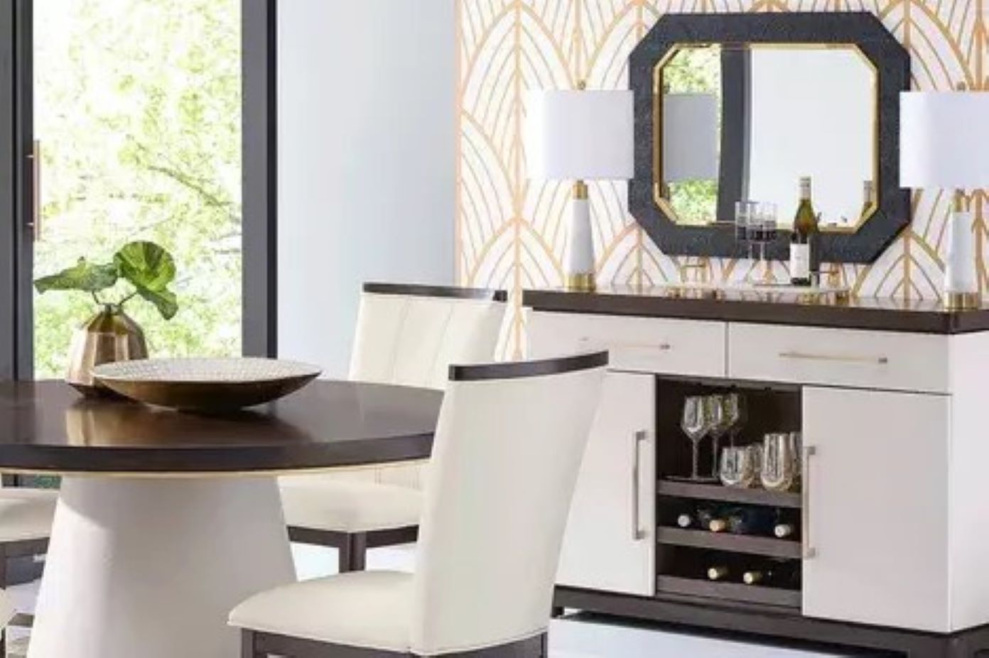 Dining room furniture set with a round table, chairs, and a sideboard with a mirror.
