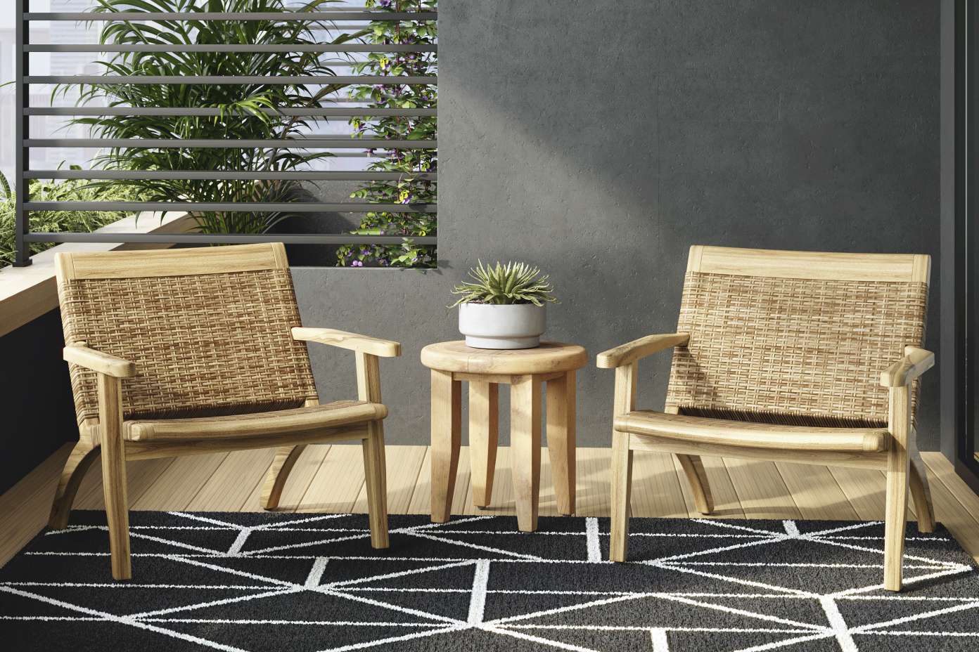 Two wooden chairs with woven backs and a small wooden table on a black and white patterned rug.

