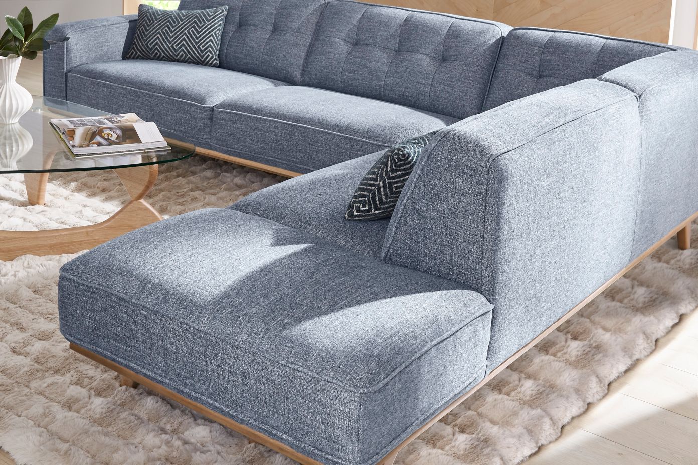blue couch and glass coffee table