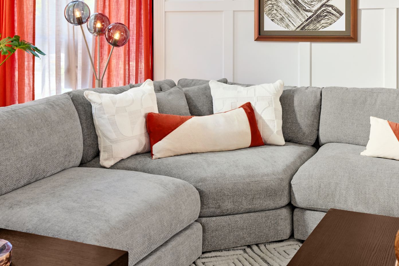 Gray sectional sofa with decorative pillows.
