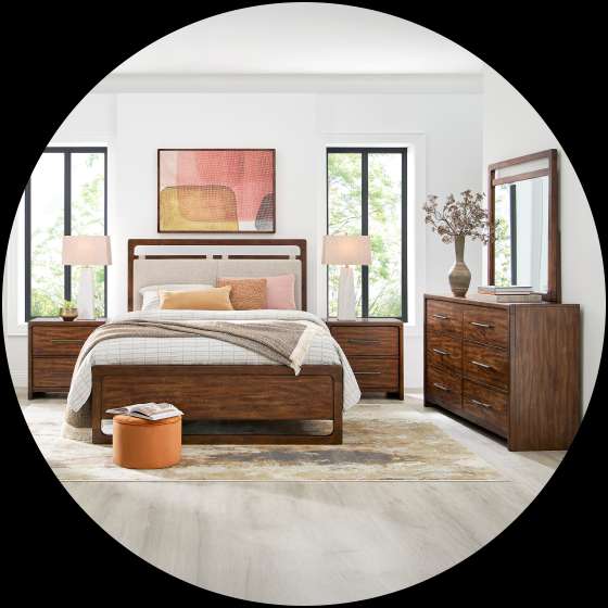 Bedroom furniture set with a bed, nightstands, dresser, and mirror.
