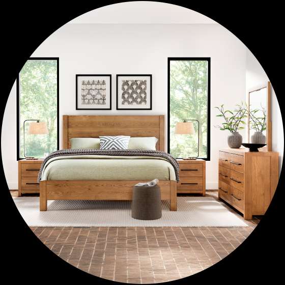 Bedroom furniture set with a bed, nightstands, dresser, and mirror.
