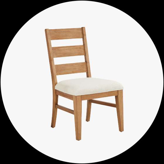 Wooden dining chair with a cream-colored upholstered seat and a ladder back.
