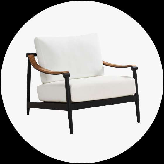 Black framed armchair with white cushions and brown armrests.
