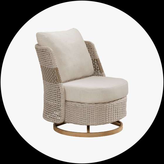 A beige woven outdoor swivel chair with a cushion and pillow.

