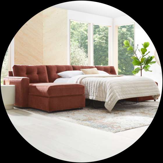 A rust-colored sectional sofa with a pull-out bed.
