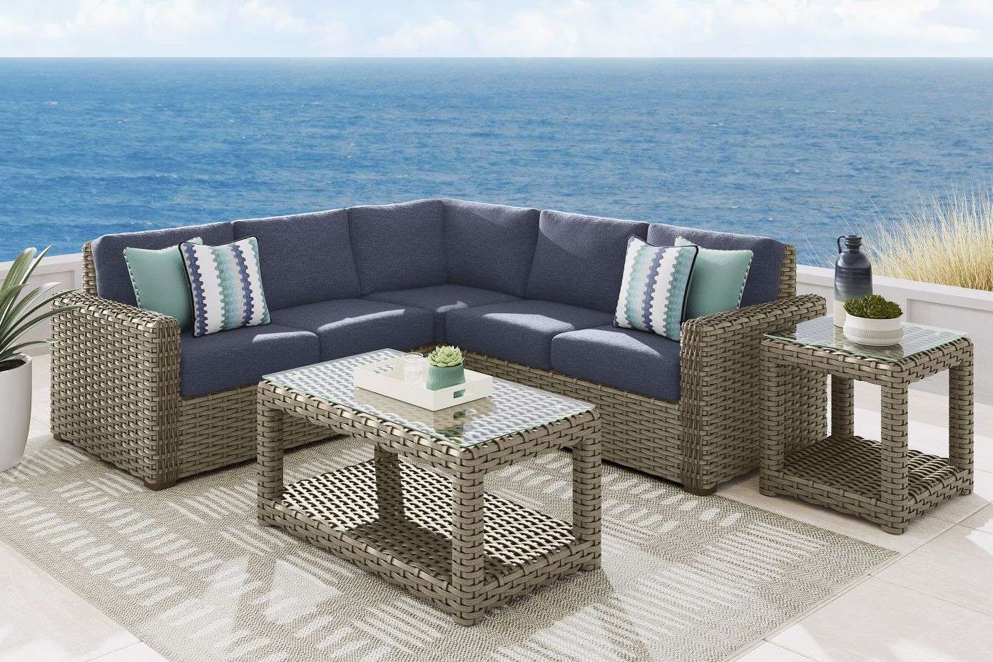Outdoor sectional sofa with a coffee table and side table.
