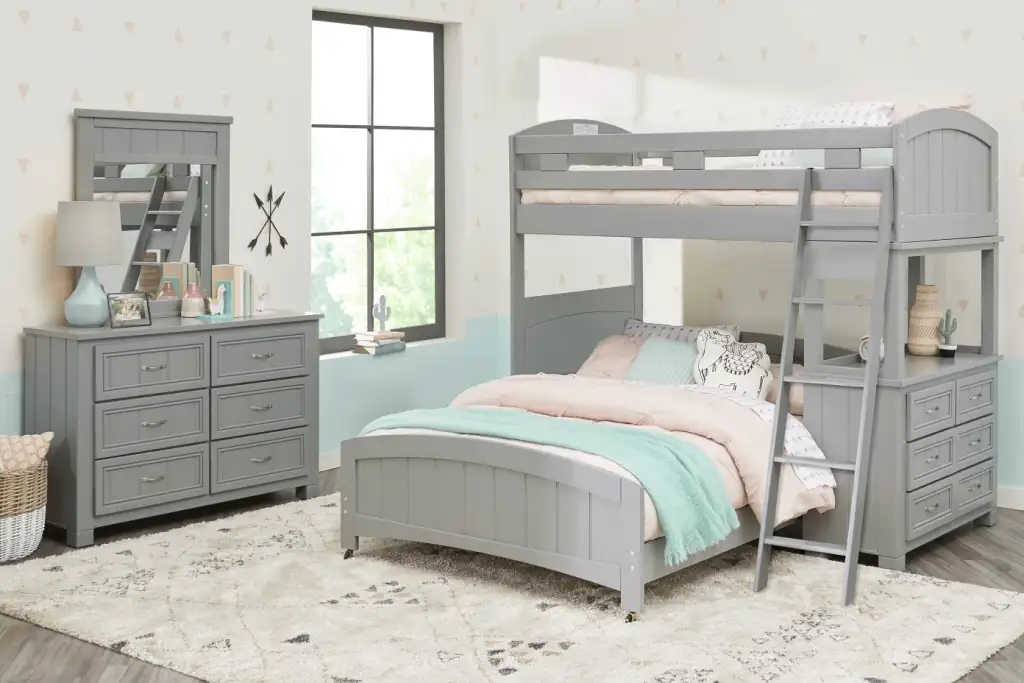 Gray bunk bed with dresser and rug.
