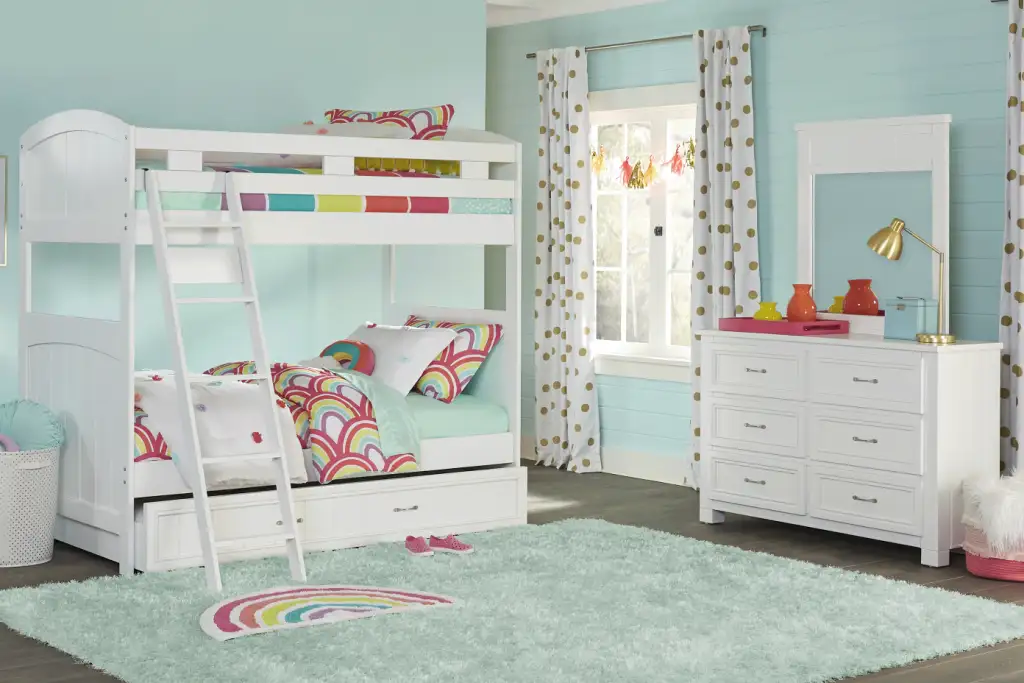 White bunk bed with a dresser and a fluffy rug.
