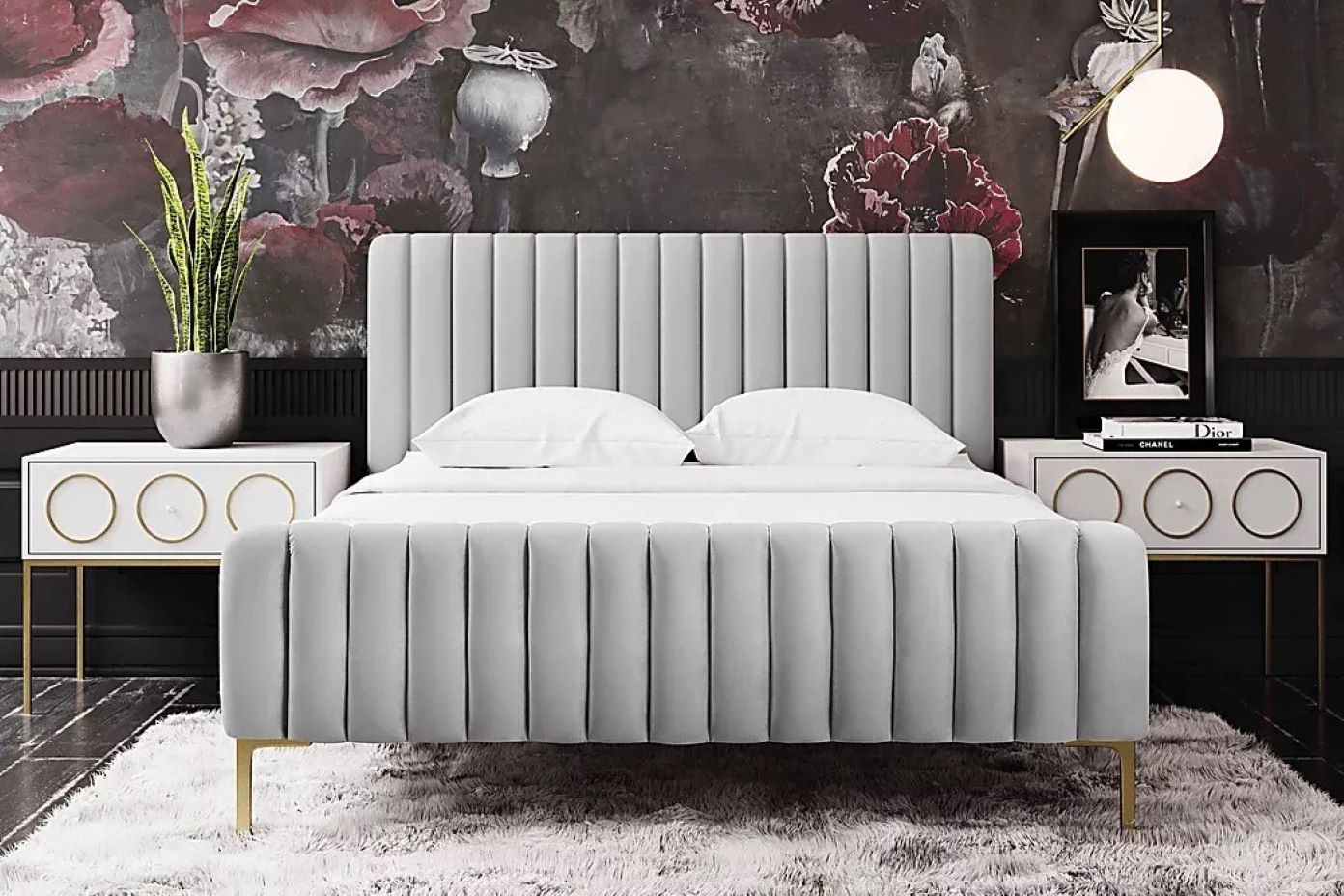 Gray upholstered bed with a fluted headboard and footboard, with gold legs.
