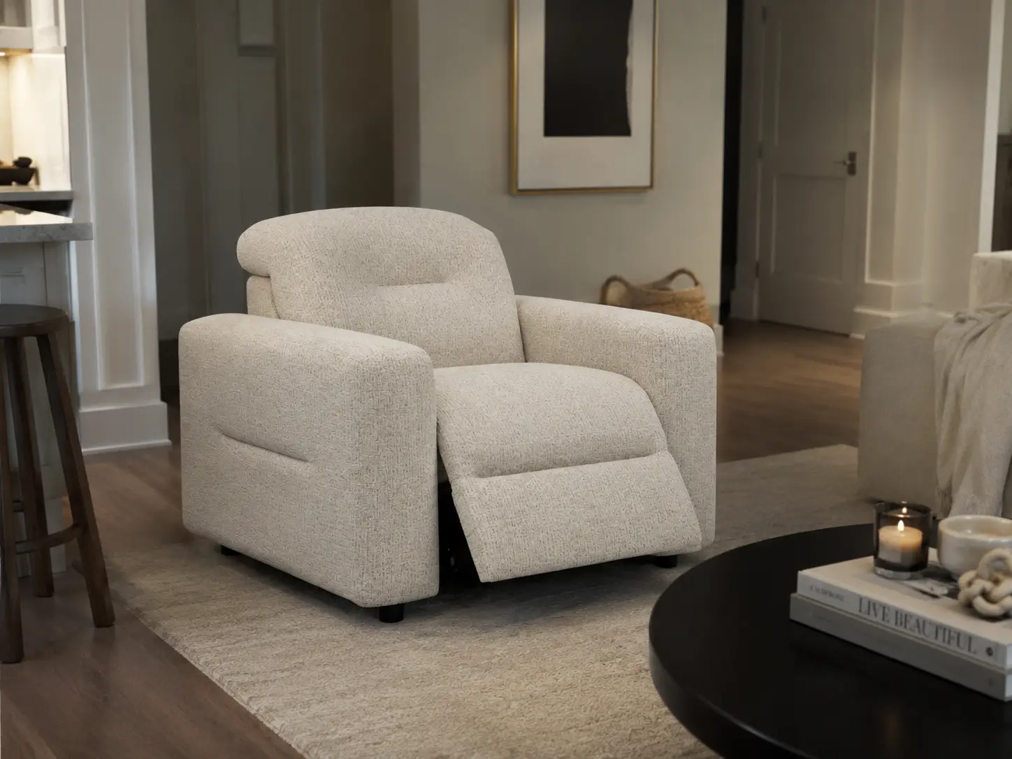 A cream-colored, textured fabric recliner chair sits on a rug in a modern living room.